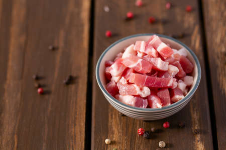 bacon cubes on wooden surfaceの写真素材