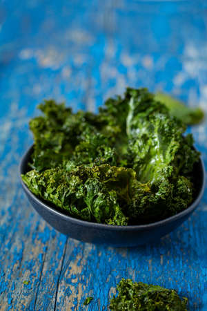 kale chips on a wooden surface