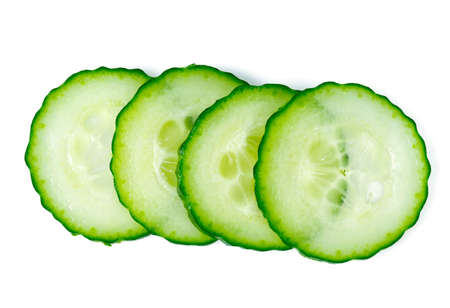 cut cucumbers isolated on whiteの写真素材