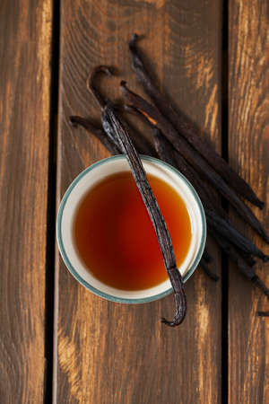 vanilla extract on wooden surfaceの写真素材