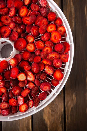 Sliced strawberry on a fruit dryer rack
