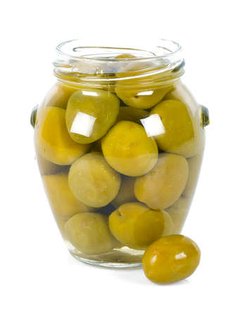 Pickled olives in a glass jar isolated on whiteの写真素材