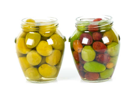 Pickled olives in a glass jar isolated on whiteの写真素材