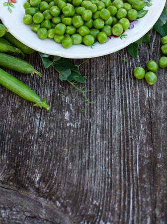 fresh pea on dark wooden surfaceの写真素材