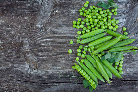 fresh pea on dark wooden surfaceの写真素材