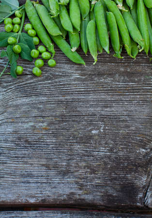 fresh pea on dark wooden surfaceの写真素材