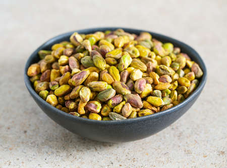pistachio nuts on granite surfaceの写真素材