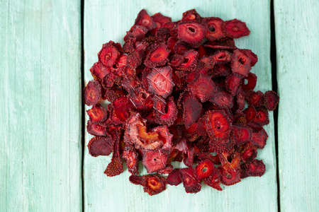 dried sliced strawberry on a wooden surfaceの写真素材