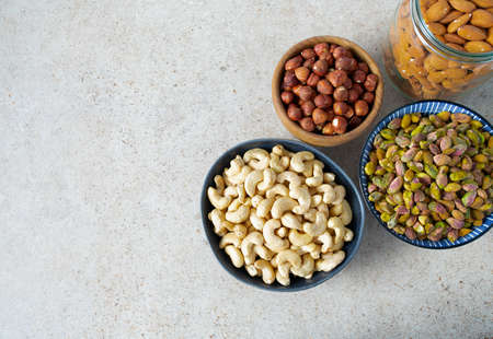 fresh nuts and dried fruis on granite surface