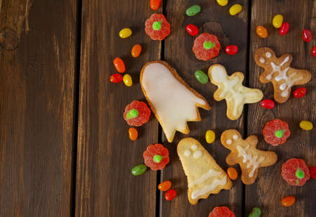 halloween sweets on dark wooden surface