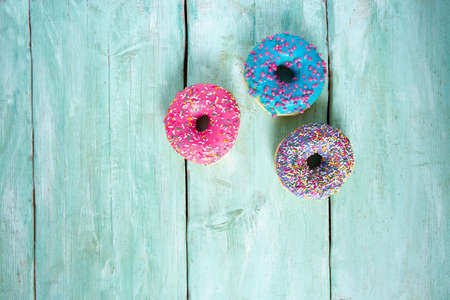 colorful doughnuts on turquoise surface
