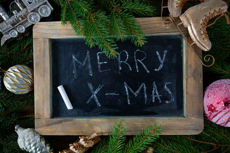 Christmas decoration and 'merry x-mas' on chalkboardの写真素材