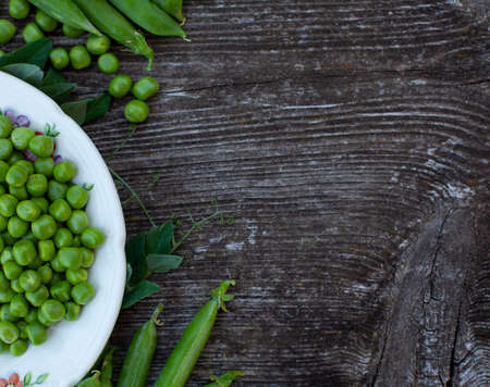 fresh pea on dark wooden surfaceの写真素材