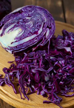 red cabbage on brown wooden surfaceの写真素材