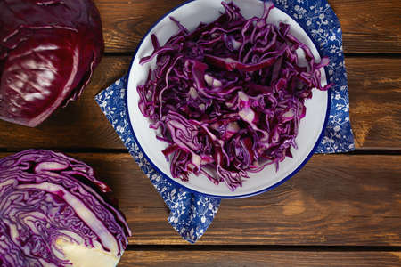 red cabbage on brown wooden surfaceの写真素材