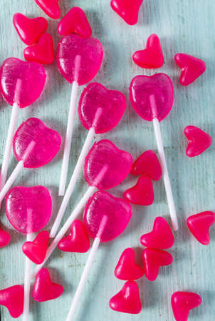 heart-shaped candies on turquoise wooden surface