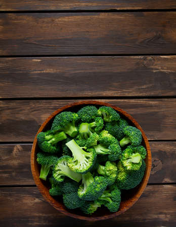 fresh broccoli on wooden surfaceの写真素材
