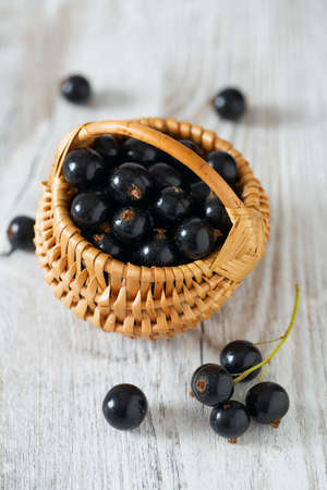black currant on wooden surfaceの写真素材