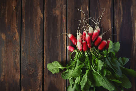 fresh radish on a dark wooden surface