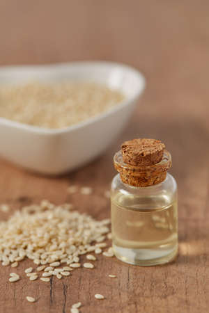 sesame oil in a miniature jar on wooden surfaceの写真素材