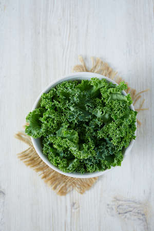 fresh kale on wooden surfaceの写真素材