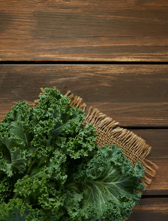 fresh kale on wooden surfaceの写真素材