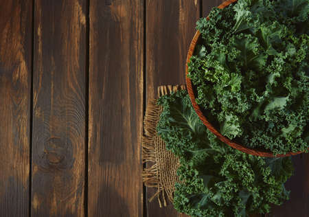 fresh kale on wooden surface