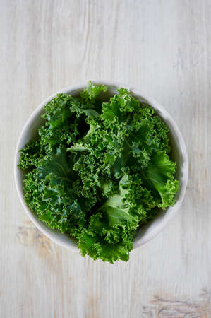 fresh kale on wooden surfaceの写真素材