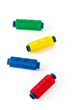 sewing items, needles, thread on white background