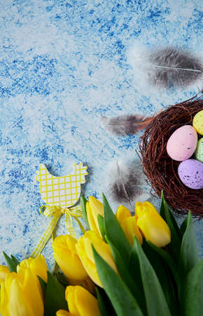 Easter decoration with tulips on oainted blue surface