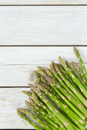 fresh green asparagus on wooden surfaceの写真素材