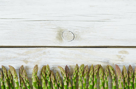 fresh green asparagus on wooden surfaceの写真素材