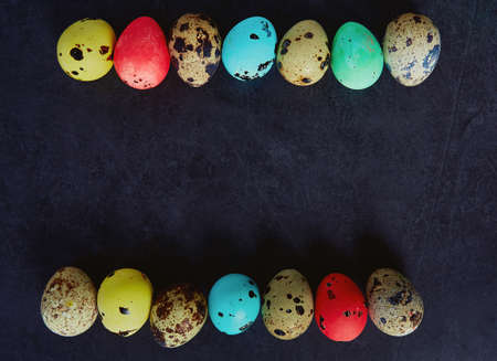painted quail eggs on stone surface