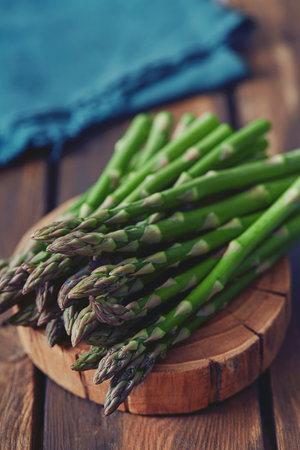 fresh green asparagus on wooden surfaceの写真素材