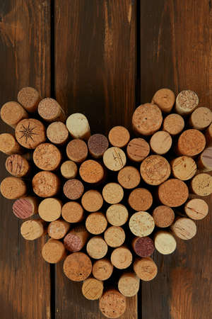 heart shape made with wine corks on wooden surfaceの写真素材