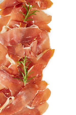 Prosciutto crudo isolated on white background. Italian or Spanish traditional dried meat.の写真素材