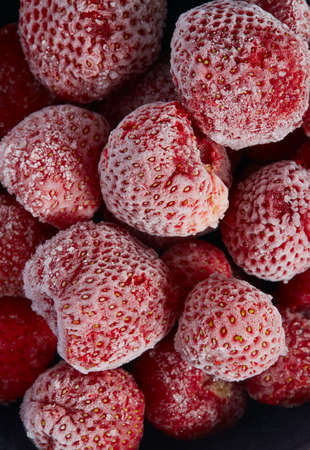 Frozen strawberries isolated on white background. Berries are being preserved for winter.の写真素材