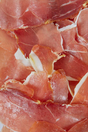 Prosciutto crudo isolated on white background. Italian or Spanish traditional dried meat.の写真素材