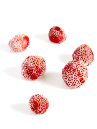 Frozen strawberries isolated on white background. Berries are being preserved for winter.の写真素材