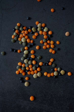 lentil assortment on black stone surfaceの写真素材
