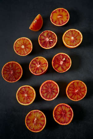 blood oranges on dark stone surfaceの写真素材