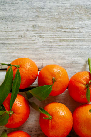 tangerines with green leaves on turquoise wooden backgroundの写真素材