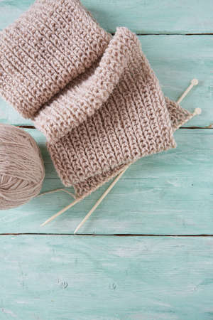knitted scarf on turquoise wooden backgroundの写真素材