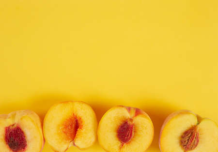 Peaches on yellow paper background. Food border and copy space for your text.の写真素材