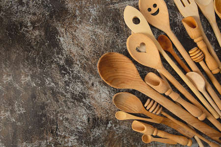 beautiful wooden spoons and utensils on stone surfaceの写真素材