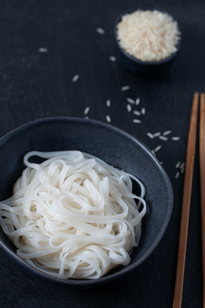 rice nudles on dark stone surfaceの写真素材