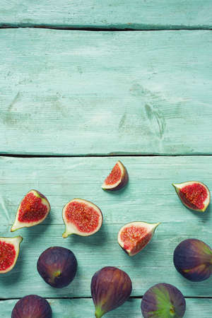 fresh figs on wooden surface, top view and empty space for your textの写真素材