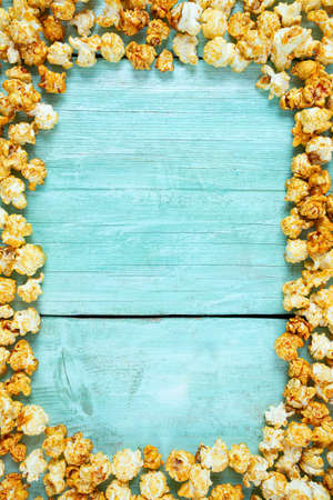 caramelized popcorn on turquoise wooden surfaceの写真素材