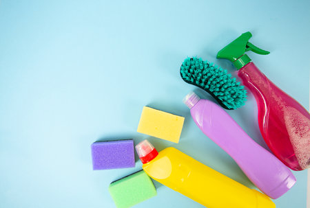 Household tems, domestic cleaning sanitary supplies on blue surface