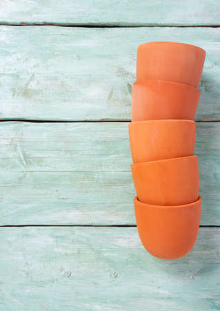 clay pots on turquoise wooden surfaceの写真素材